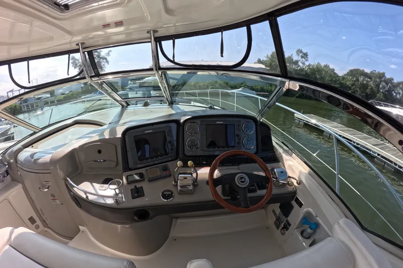 Slide: The Image of 2007 Sea Ray 44 Sundancer helm with modern controls and panoramic view. - 11