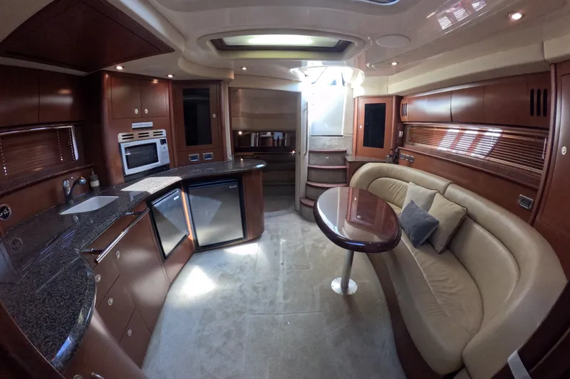 Slide: The Image of Luxurious 2007 Sea Ray 44 Sundancer yacht interior with modern kitchen and cozy seating area. - 65