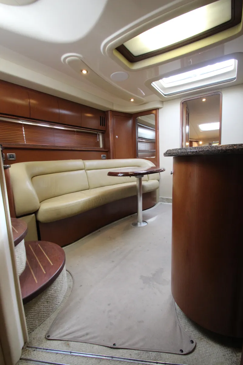 Slide: The Image of 2007 Sea Ray 44 Sundancer interior with beige seating and wooden accents. - 47