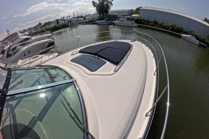 Slide: The Image of 2007 Sea Ray 44 Sundancer yacht docked in a marina under a sunny sky. - 18