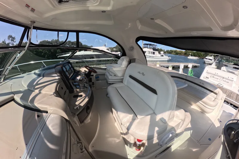 Slide: The Image of Luxurious 2007 Sea Ray 44 Sundancer yacht interior with plush seating and modern dashboard. - 9