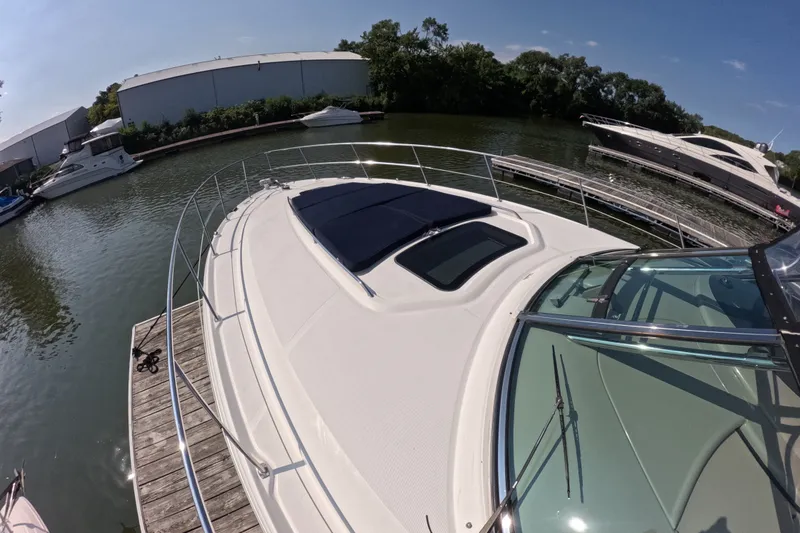 Slide: The Image of 2007 Sea Ray 44 Sundancer yacht docked at marina under clear blue sky. - 14