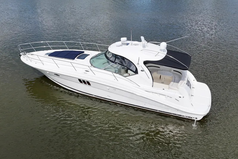 Slide: The Image of 2007 Sea Ray 44 Sundancer yacht on calm water, showcasing sleek design and luxury features. - 2