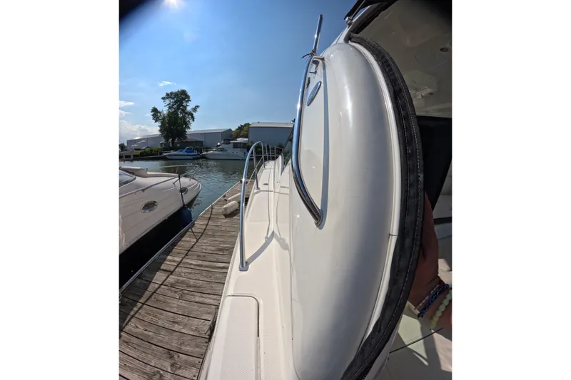 Slide: The Image of 2007 Sea Ray 44 Sundancer yacht docked at marina under clear blue sky. - 13