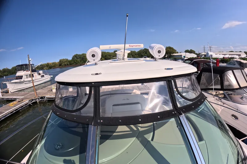 Slide: The Image of 2007 Sea Ray 44 Sundancer yacht docked at marina under clear blue sky. - 17