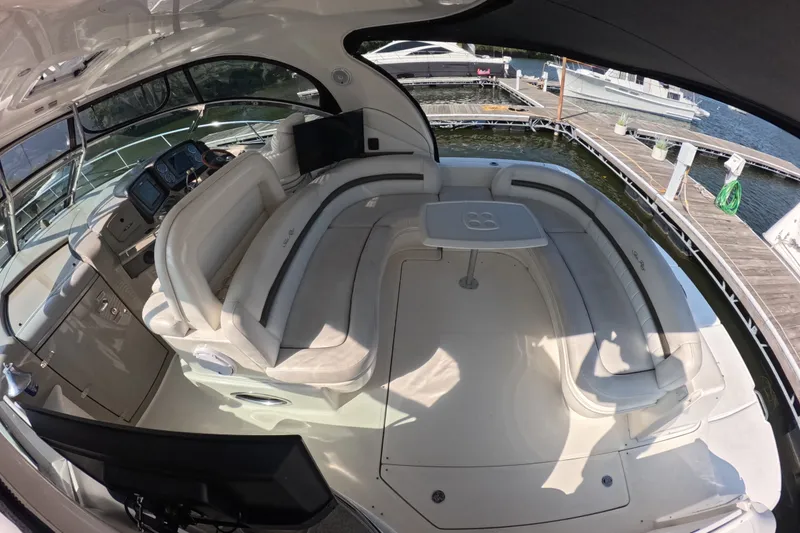 Slide: The Image of 2007 Sea Ray 44 Sundancer yacht interior with plush seating and control panel. - 7