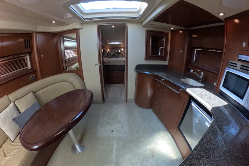 Slide: The Image of Luxurious interior of 2007 Sea Ray 44 Sundancer yacht with kitchen and seating area. - 56