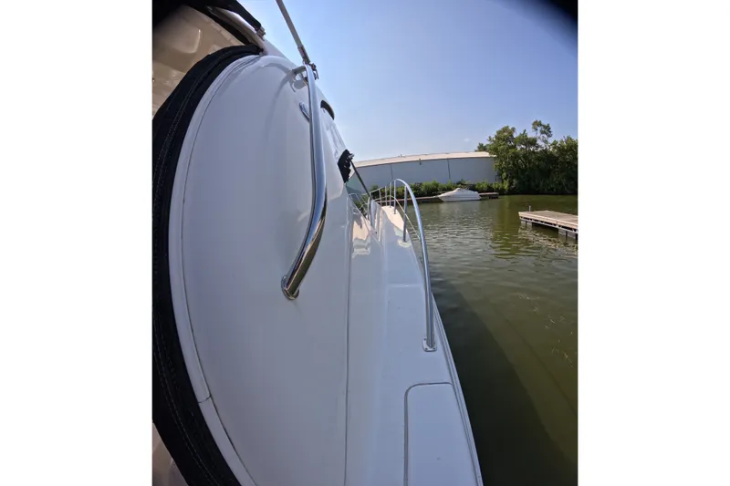 Slide: The Image of 2007 Sea Ray 44 Sundancer yacht docked on calm water, side view. - 19