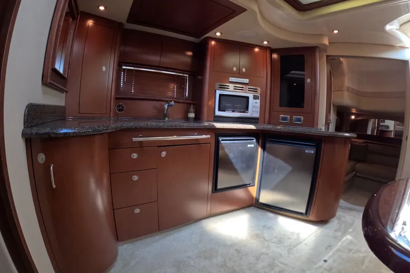 Slide: The Image of Luxurious 2007 Sea Ray 44 Sundancer yacht kitchen with wood cabinetry and modern appliances. - 41