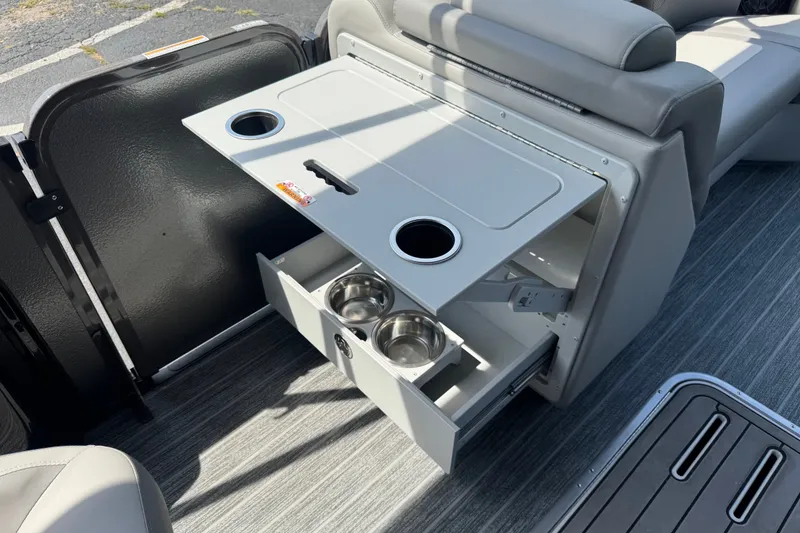 Slide: The Image of Premier 230 Sunsation RL - CL 2027 boat interior with fold-out table and cup holders. - 15