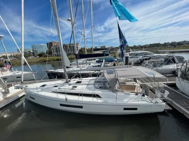 The Image of 2023 Beneteau Oceanis 40.1 sailboat docked at a marina under a clear sky. - 0