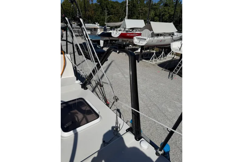 Slide: The Image of 2019 J Boats J/121 sailboat on land, surrounded by other boats and trees. - 31