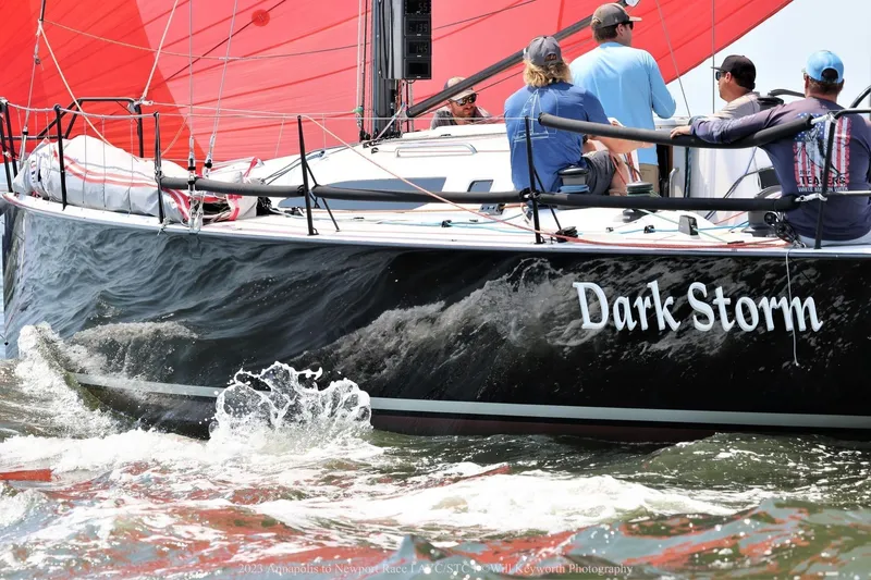 Slide: The Image of 2019 J Boats J/121 "Dark Storm" sailing with red sails and crew on deck. - 1