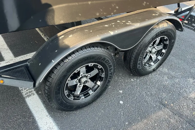 Slide: The Image of Trailer wheels of 2020 Tracker Targa V-19 WT Tournament Edition on asphalt. - 19