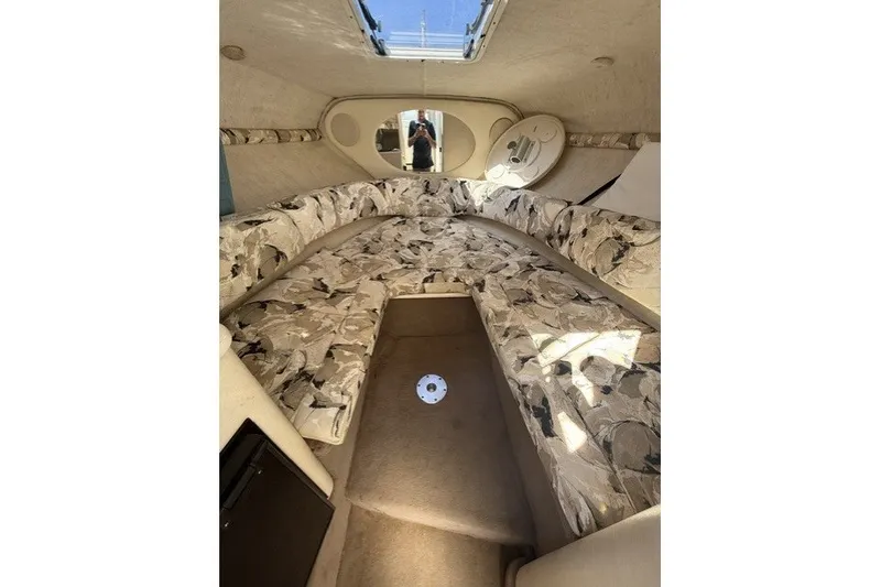 Slide: The Image of Interior cabin of 2000 Sea Ray 240 Sundancer with patterned seating and skylight. - 18