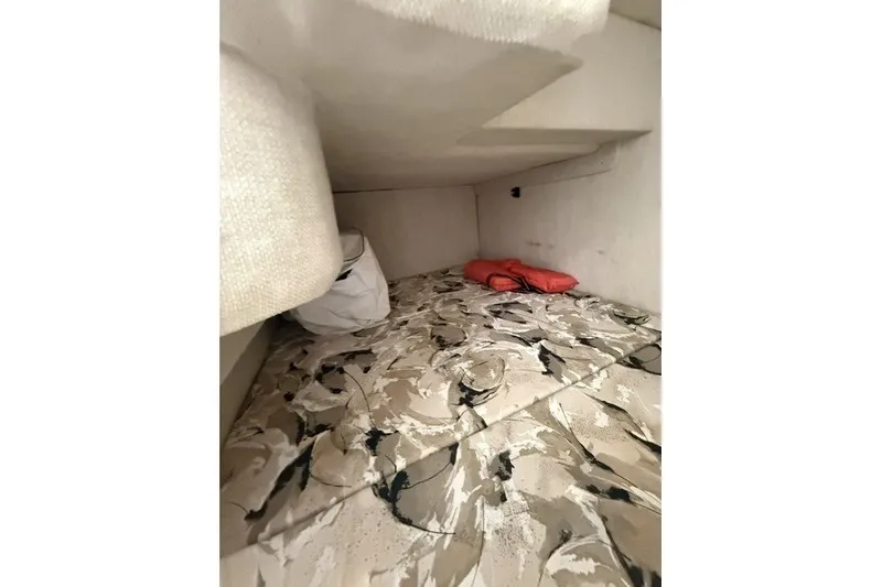 Slide: The Image of Interior cabin of 2000 Sea Ray 240 Sundancer with patterned bedding and life jackets. - 20
