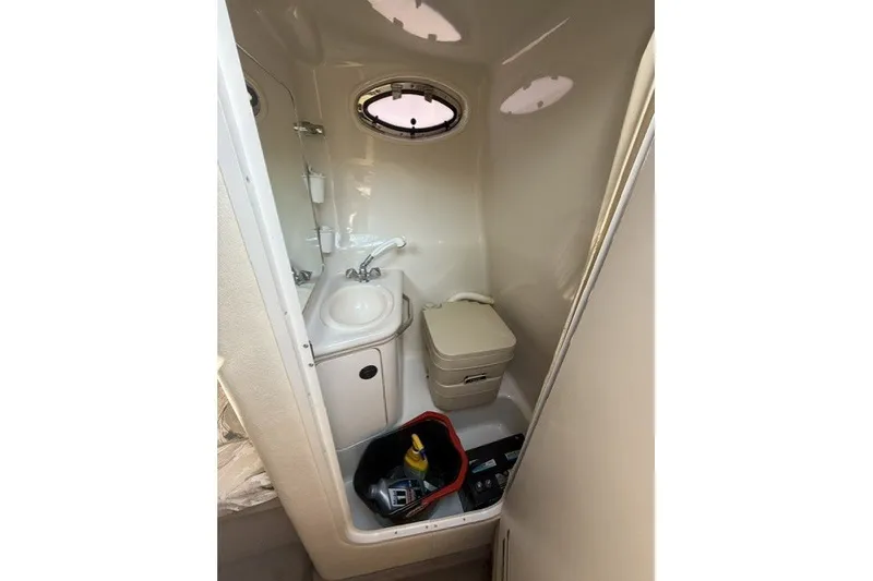 Slide: The Image of Compact bathroom in 2000 Sea Ray 240 Sundancer boat with sink and toilet. - 16