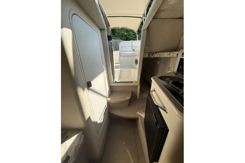 Slide: The Image of Interior view of 2000 Sea Ray 240 Sundancer cabin with kitchenette and steps. - 17