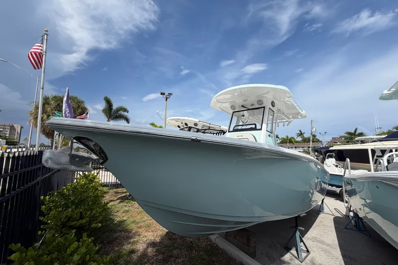 The Image of 2026 Sea Pro 245FLXR Sandbar boat displayed outdoors under a clear blue sky. - 1