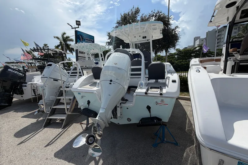 Slide: The Image of 2026 Sea Pro 245FLXR Sandbar boat displayed outdoors with powerful outboard motor. - 7