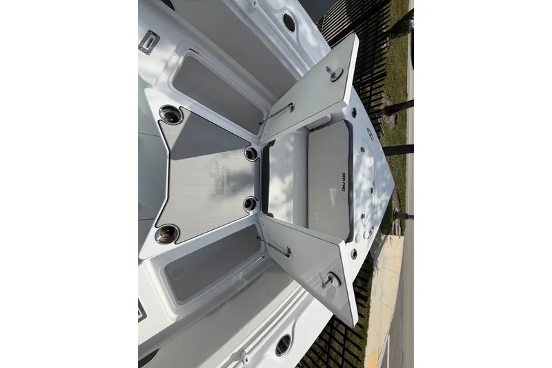 Slide: The Image of 2026 Sea Pro 245FLXR Sandbar boat storage compartments open, showcasing spacious design. - 44