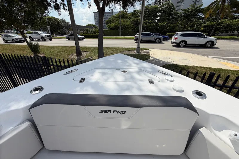 Slide: The Image of 2026 Sea Pro 245FLXR Sandbar boat, parked near a road with passing cars. - 21