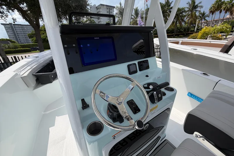 Slide: The Image of Interior view of 2026 Sea Pro 245FLXR Sandbar boat with modern steering console. - 9