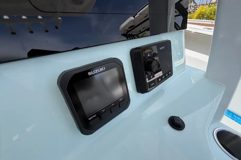 Slide: The Image of Dashboard of 2026 Sea Pro 245FLXR Sandbar boat with Suzuki and Audison controls. - 13