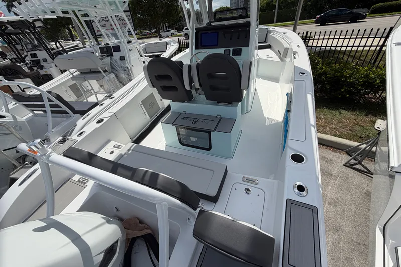 Slide: The Image of 2026 Sea Pro 245FLXR Sandbar boat interior with seating and console, displayed outdoors. - 8
