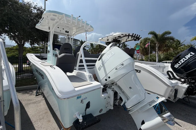 Slide: The Image of 2026 Sea Pro 245FLXR Sandbar boat with Suzuki outboard motor, parked outdoors. - 6