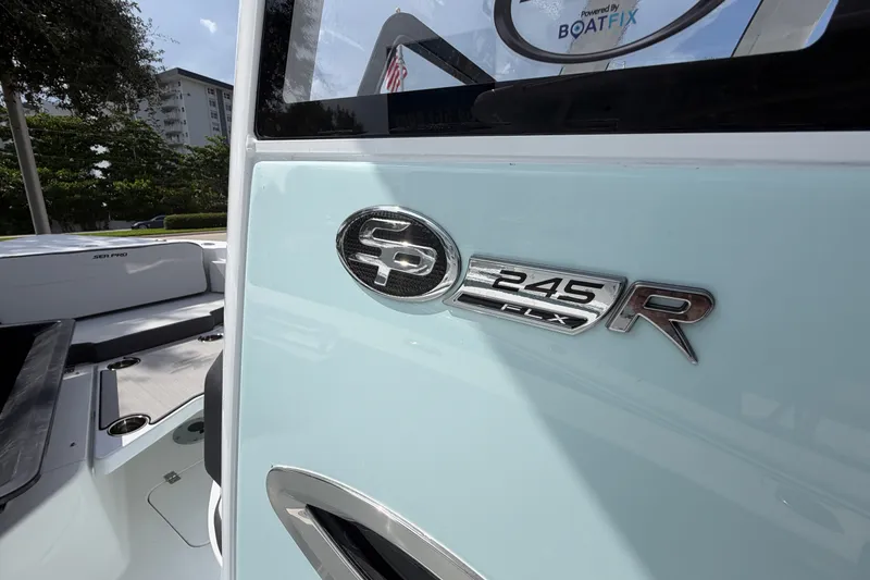 Slide: The Image of 2026 Sea Pro 245FLXR Sandbar boat, close-up of logo and interior details. - 5