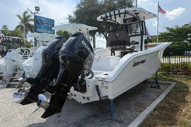Slide: The Image of 2027 Sea Pro 262 DLX boat with dual Suzuki outboard motors, displayed outdoors. - 5