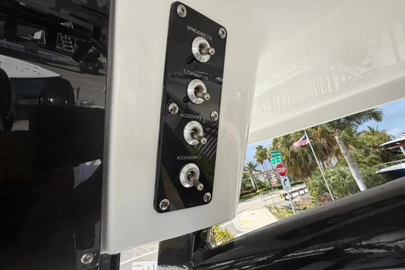 Slide: The Image of Control panel on 2027 Sea Pro 262 DLX boat with toggle switches for accessories. - 42
