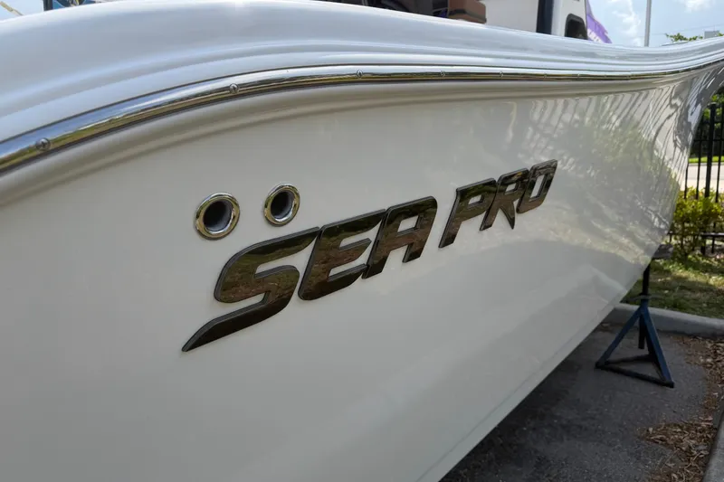 Slide: The Image of 2027 Sea Pro 262 DLX boat side view with logo and sleek design. - 3