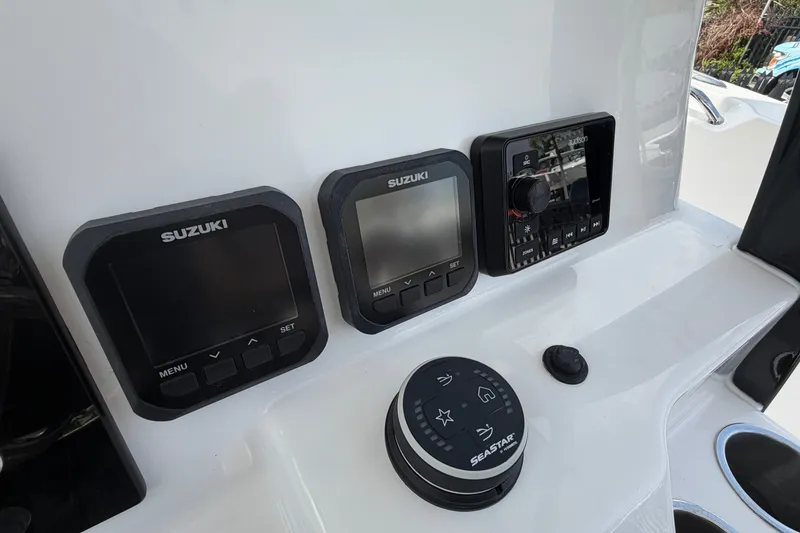 Slide: The Image of 2027 Sea Pro 262 DLX dashboard featuring Suzuki displays and SeaStar controls. - 32