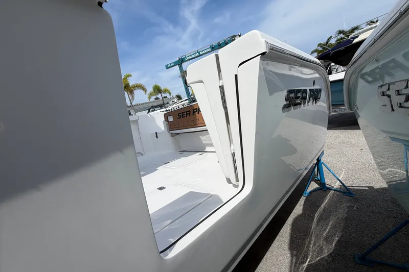 Slide: The Image of 2027 Sea Pro 262 DLX boat on display, showcasing sleek design and open deck. - 8