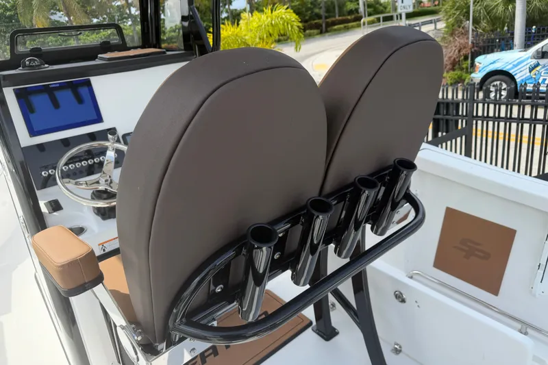 Slide: The Image of 2027 Sea Pro 262 DLX boat interior with dual seats and rod holders. - 10