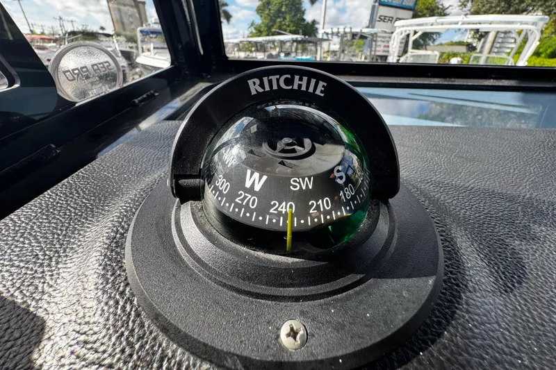Slide: The Image of Compass on 2026 Sea Pro 292 DLX boat dashboard, showing southwest direction. - 27
