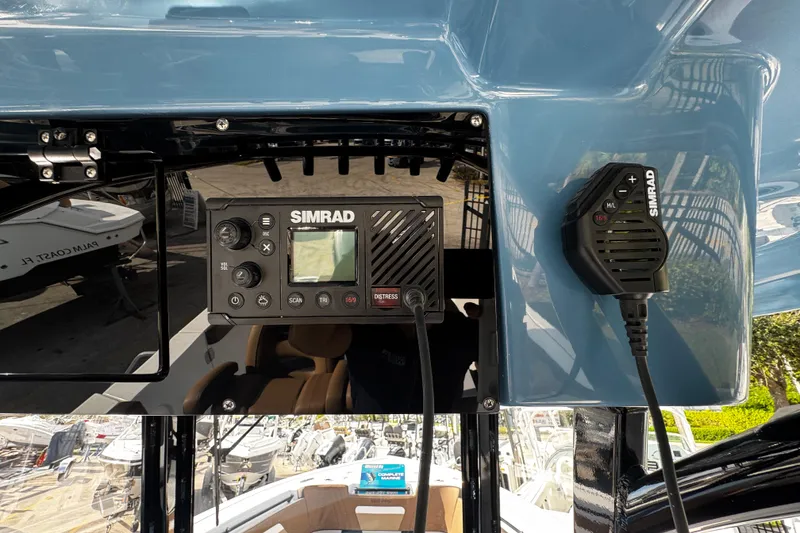 Slide: The Image of 2026 Sea Pro 292 DLX boat with Simrad marine electronics display and microphone. - 30