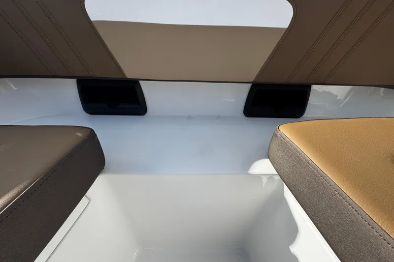 Slide: The Image of 2026 Sea Pro 292 DLX boat interior seating with brown and tan upholstery. - 31