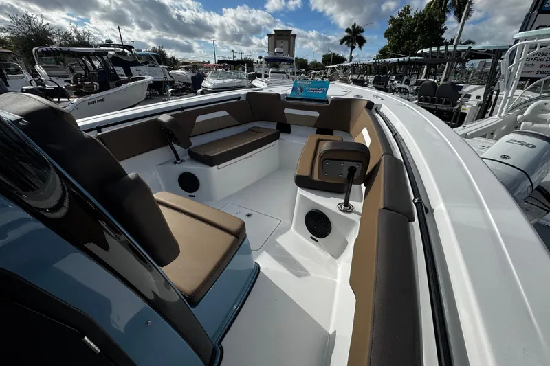 Slide: The Image of 2026 Sea Pro 292 DLX boat interior with brown seating and modern design. - 7
