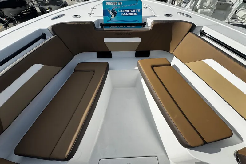 Slide: The Image of 2026 Sea Pro 292 DLX boat interior with tan seating and white deck. - 8