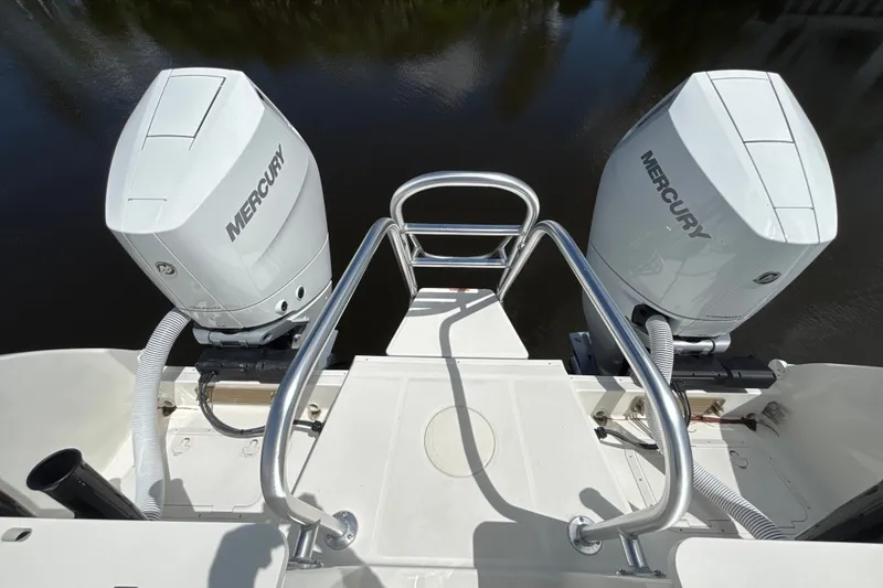Slide: The Image of 2027 World Cat 325 CC boat with dual Mercury outboard engines on a calm water backdrop. - 17