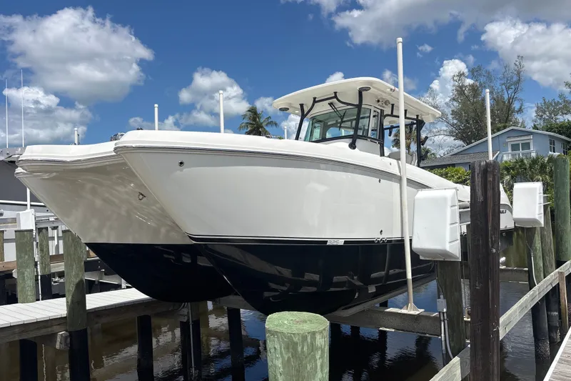 The Image of 2027 World Cat 325 CC boat docked under a clear blue sky. - 1