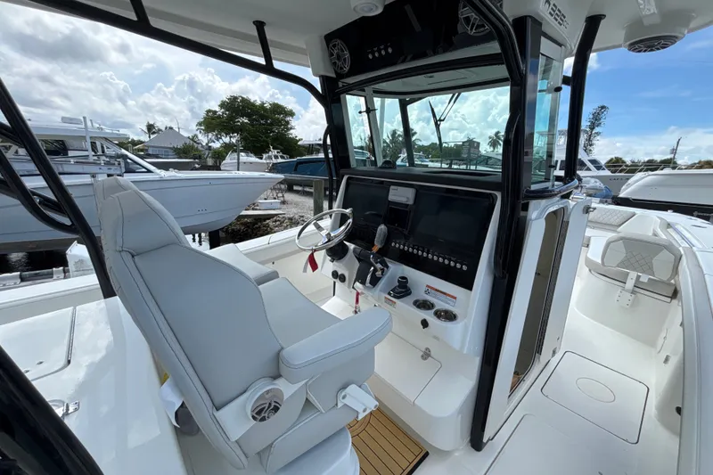 Slide: The Image of 2027 World Cat 325 CC boat cockpit with modern controls and seating. - 14