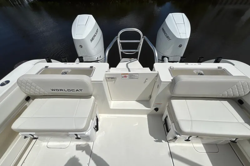 Slide: The Image of 2027 World Cat 325 CC boat with dual Mercury engines and cushioned seating. - 19