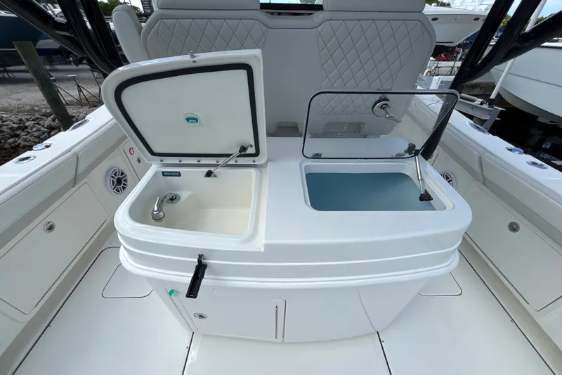 Slide: The Image of 2027 World Cat 325 CC boat interior with dual sinks and storage compartments. - 16