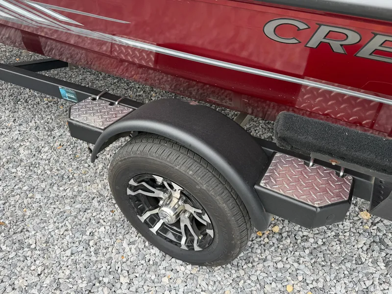 Slide: The Image of A red 2022 Crestliner CXF 189 on a trailer with stylish rims and non-slip step plates. - 23