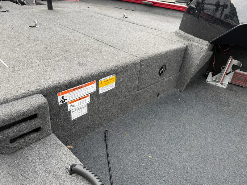Slide: The Image of The image shows the interior of a 2022 Crestliner CXF 189 boat with gray carpeting. - 14