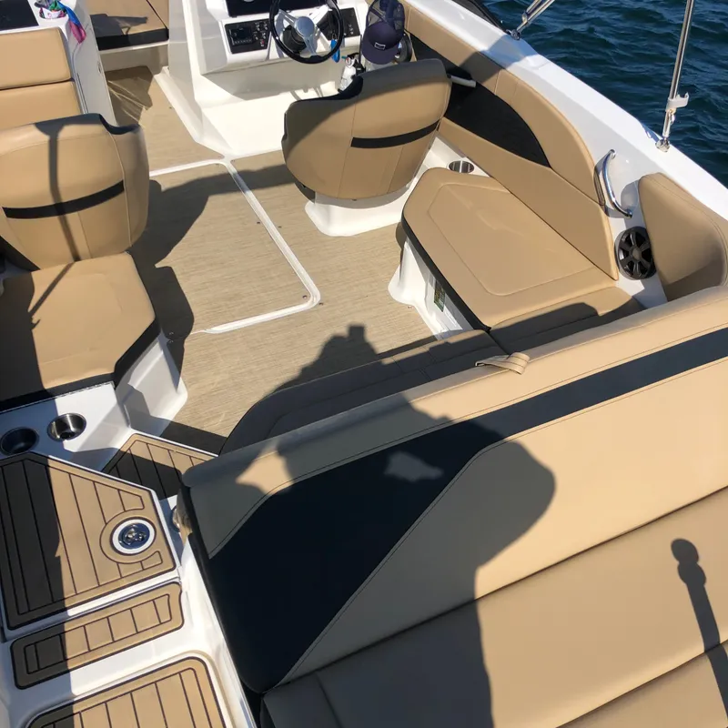 Slide: The Image of Interior of a Sea Ray SPX 210 Outboard with beige seating and modern design. - 7